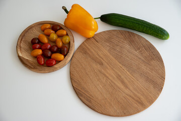 Bright culinary ingredients, vegetables and microgreens are laid out on the table near the wooden cutting board. Healthy Eating