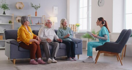 Elderly patients and a nurse high-five each other after a medical checkup and conversation at a nursing home. Healthcare session promotes a supportive atmosphere in the care of the elderly.