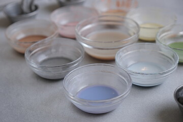 Painting colours for azulejos tile painting workshop. Multiple paint bowl with blue color in front