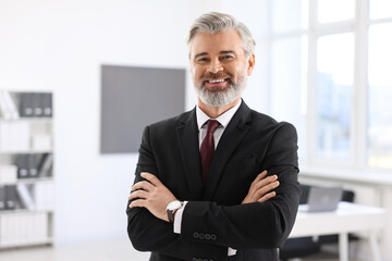 Portrait of banker with crossed arms in office