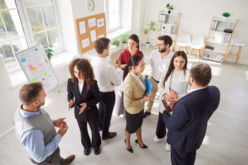 Concentrated, diverse business people conducting a meeting, presentation, or event in an office....