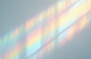 Blurred rainbow light refraction texture. Diagonal holographic flare on white wall. Shadows create natural light effects. Colorful background design for modern presentation. For photo overlays.