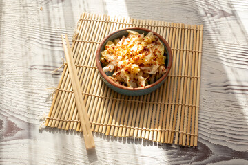 kimchi in fresh white bowl close-up on gray background	