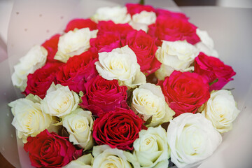 Live red and white roses in a bouquet.