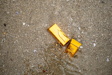gold nuggets on the beach in the sea waves