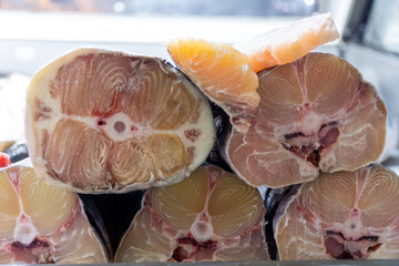 Detailed cross-sections of fresh catfish slices showcasing intricate muscle patterns and textures. 