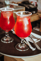 photo of sugar frosted mocktails with maraschino cherries and sparkling water in coffee shop