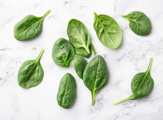 Obraz premium Sage green, fresh spinach leaves on a white marble background, in a flat lay, top view. Stock photo contest winner, food photography, stock photo, award-winning, high resolution, high detail, colorful