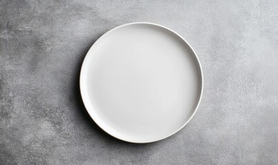 An empty matte white dinner plate sits centered on a textured gray background, ready for culinary creations.