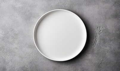 An empty white plate sits on a textured gray surface, ready for a culinary creation or elegant display.