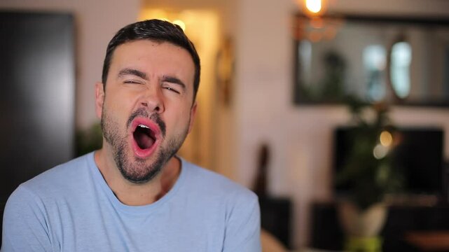 Man yawning at home during the night time