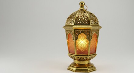 Illuminated ornate lantern casting a warm glow on a plain backdrop creating a serene atmosphere