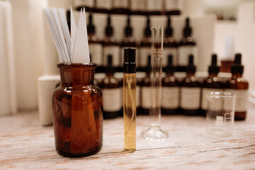 Glass mock up bottle with fragrance essential oil and transparent brown bottle with white paper...