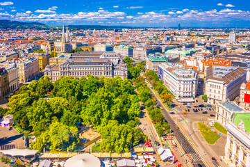 A breathtaking aerial photograph of Vienna, Austria, showcasing its impressive skyline with historic landmarks, and green parks, blending cultural heritage with urban development
