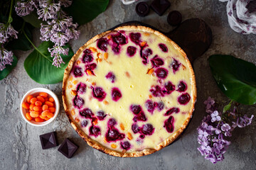 Cherry pie on a gray background. Berry pie for breakfast. View from above. Close-up
