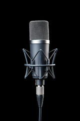 Studio condenser microphone in shock mount against black background