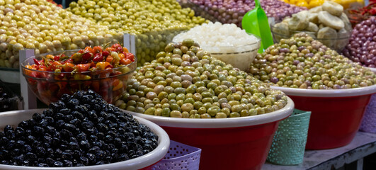 Colourful olives and fruit for sale in the souk bazaar in Meknes, Morocco. Photographed in the kissaria, covered market.