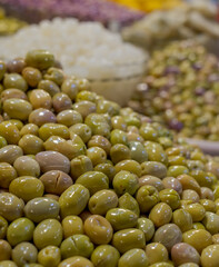 Colourful olives and fruit for sale in the souk bazaar in Meknes, Morocco. Photographed in the kissaria, covered market.