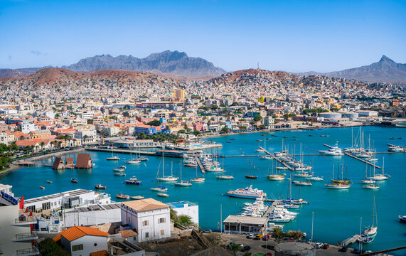Aerial view of vibrant and colorful day over Mindelo city, and its cove full of ships at docks, Sao Vicente island, Cape Verde