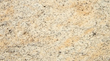 Beige speckled granite surface with natural grain pattern and rough texture providing timeless durability and warmth for architectural, kitchen, bathroom, or interior surface design themes
