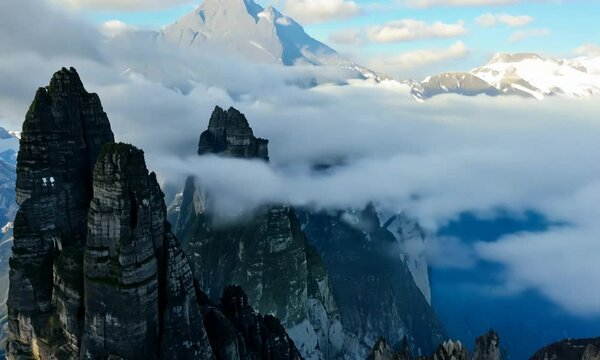 Aerial hyperlapse of high mountain peak with clouds in Dolomites, Italy