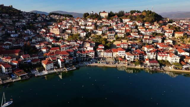 Flying over lake of Ohrid showcasing the Old Town of Ohrid in Golden hour