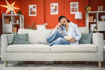 Fototapeta premium relax mature japanese woman enjoy while watch movie on the television