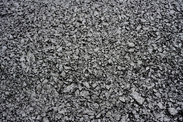 Close-up of rough asphalt pavement texture
Detailed view of coarse asphalt surface, showing compacted gravel and bitumen mix typical of roads, driveways, or parking areas.
