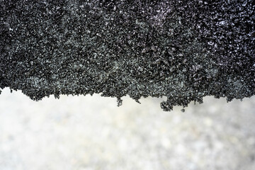 Close-up of rough asphalt texture edge
Detailed macro image of the edge of asphalt showing gritty,...