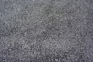 Close-up of finished asphalt road surface
Detailed view of a newly paved asphalt road showing its uniform, coarse texture made of compacted gravel and bitumen.
