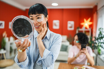 delight mature japanese woman with eye patches look in the mirror