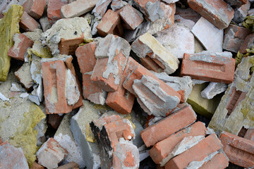 Pile of broken bricks and construction debris
Discarded bricks, insulation, and rubble from a demolition or renovation site form a messy pile of construction waste materials.

