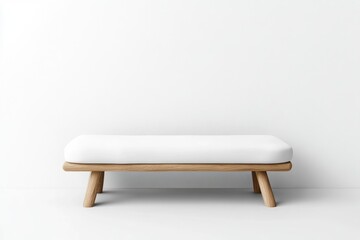 Simple white wooden bench against a white wall