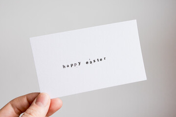 Minimalist Happy Easter card with hand-holding caucasian adult