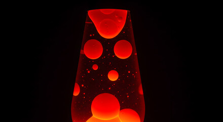 Captivating red lava lamp with floating blobs in a darkened ambiance creates a retro vibe