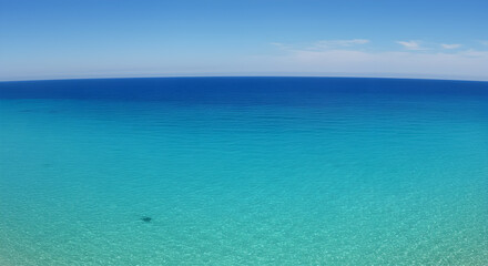 Mesmerizing gradient of turquoise and azure waters meeting a clear cerulean sky