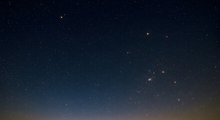 Fototapeta premium Enchanting midnight sky dotted with golden stars in a gradient of cosmic blues