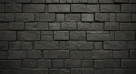 A dark gray brick wall with varying sizes and shapes of bricks arranged in a horizontal pattern