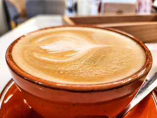 close-up of latte art in a brown mug. Beautiful coffee creation.