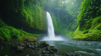 Lush green landscape with waterfall flowing into a serene river.