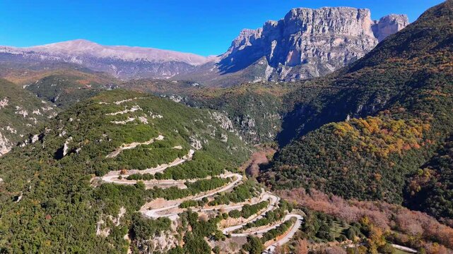 Drone shot of Cars driving over an impressive hairpin roud in the mountains