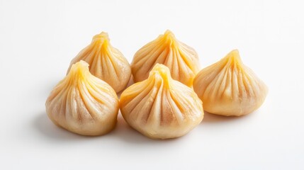 Fresh steamed modak dumplings presented on white background. Light color of dumplings, white backdrop creates visually appealing image. Dish traditional Indian sweet food often associated with
