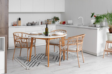 Served dining table in interior of light kitchen