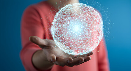 Illuminated Digital Sphere Floating Above Hand Against a Gradient Blue Background in Studio Shot