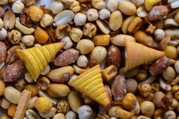 Colorful crunchy treats mixed with an assortment of nuts and seeds create a vibrant snack medley on a sunny afternoon