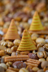 Delicate conical treats surrounded by an array of colorful grains at a vibrant outdoor market in early autumn