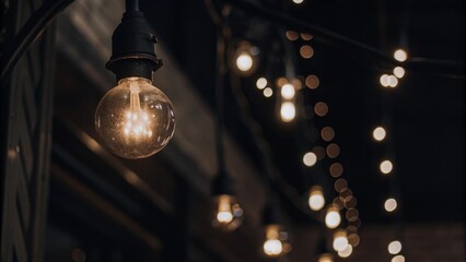 Warm vintage light bulbs hanging in a dimly lit space creating a cozy ambiance for an evening gathering