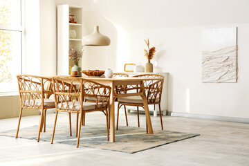 Interior of light room with dried lavender, grapes and tea on dining table