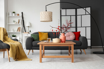 Interior of living room with sofa, table and decor for Chinese New Year celebration