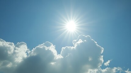 Bright sun shines over fluffy white clouds in a clear blue summer sky.